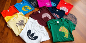 Colourful limited edition t-shirts on a wooden surface.