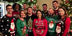 Group in funny Christmas jumpers at festive party.