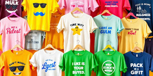 Colourful funny T-shirts hanging on vibrant display.