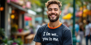 Person in a funny t-shirt smiling outdoors.