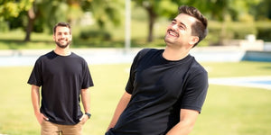 A man in a casual XXXL T-shirt outdoors.