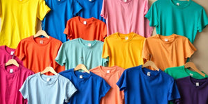 Colourful t-shirts in an inviting display for gifting.