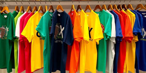 Display of vibrant 4XL T-shirts on hangers.