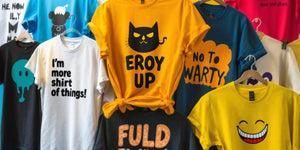 Colourful funny t-shirts hanging on display.