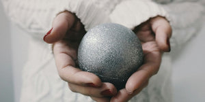 woman holding gray bath bomb