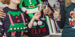 Christmas party with people wearing funny festive jumpers